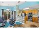Bright kitchen with stainless appliances, wood cabinets, and a blue accent wall open to an adjacent dining area at 739 Tall Oaks Dr., Myrtle Beach, SC 29588