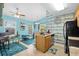 View of kitchen and dining area with blue walls, wood look accents, stainless appliances, and views to exterior at 739 Tall Oaks Dr., Myrtle Beach, SC 29588