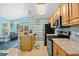 View of kitchen featuring oak cabinets, light countertops, stainless appliances, and open flow to adjacent dining area at 739 Tall Oaks Dr., Myrtle Beach, SC 29588