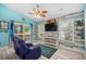 Comfortable living room with a TV, accent wall, and sliding glass doors to the outdoor deck at 739 Tall Oaks Dr., Myrtle Beach, SC 29588