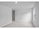 A bright, empty bedroom featuring carpet flooring, neutral paint, and an open door at 784 Wapama St., Little River, SC 29566