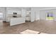 Open-concept living area with kitchen featuring an island, stainless appliances, white cabinetry, and hardwood floors at 796 Wapama St., Little River, SC 29566