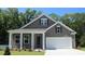 Charming single-Gathering home featuring a two-car garage, neutral color siding and a covered front porch at 886 Ireland Dr., Longs, SC 29568