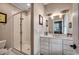 Elegant bathroom with a glass-enclosed shower, double vanity, and bright lighting, ensuring a clean space at 9 Winnowing Way, Pawleys Island, SC 29585