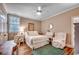 Bright bedroom featuring neutral walls, a ceiling fan, and comfortable furnishings for a relaxing retreat at 9 Winnowing Way, Pawleys Island, SC 29585