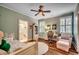 Cozy bedroom with wood floors, a ceiling fan, and ample natural light for a warm, inviting space at 9 Winnowing Way, Pawleys Island, SC 29585