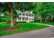 Stately two-story home featuring a full front porch, well-manicured lawn, and mature trees, radiating Southern charm at 9 Winnowing Way, Pawleys Island, SC 29585