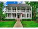 Charming two-story home features a large front porch with white columns and black shutters at 9 Winnowing Way, Pawleys Island, SC 29585