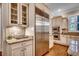 Eat-in kitchen offers stainless steel appliances, stone backsplash, and custom cabinetry at 9 Winnowing Way, Pawleys Island, SC 29585