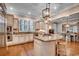 Bright eat-in kitchen features a center island with granite countertops and hardwood floors at 9 Winnowing Way, Pawleys Island, SC 29585