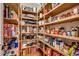 Walk-in pantry with wooden shelving provides ample space for storing dry goods at 9 Winnowing Way, Pawleys Island, SC 29585
