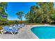 A well-maintained pool area featuring comfortable lounge chairs, and serene views overlooking a lush, green marsh at 9 Winnowing Way, Pawleys Island, SC 29585
