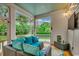 Cozy screened porch with comfortable seating, a ceiling fan, and views of the lush backyard at 9 Winnowing Way, Pawleys Island, SC 29585