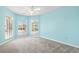 Bright bedroom with light blue walls, carpet flooring, and lots of natural light from the windows at 914 Dock Pl., Murrells Inlet, SC 29576
