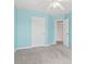 Bedroom featuring a ceiling fan, light blue walls, grey carpet, and white doors and trim at 914 Dock Pl., Murrells Inlet, SC 29576