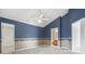 Bedroom featuring blue accent wall, neutral carpeting, and an ensuite bathroom at 914 Dock Pl., Murrells Inlet, SC 29576