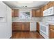Kitchen area features white appliances, wood cabinets and laminate countertops at 914 Dock Pl., Murrells Inlet, SC 29576