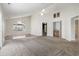 Spacious living room with vaulted ceilings, large windows, and wet bar area at 914 Dock Pl., Murrells Inlet, SC 29576