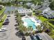 Aerial view of community pool with palm trees, lounge chairs, and parking lot at 914 Dock Pl., Murrells Inlet, SC 29576