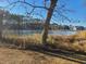 Peaceful lake surrounded by greenery, complemented by a clear blue sky and mature trees at 1025 W Plantation Dr. W # 2817, Little River, SC 29566