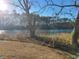 Stunning lake surrounded by trees and foliage, illuminated by the bright sun at 1025 W Plantation Dr. W # 2817, Little River, SC 29566