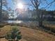 Lush backyard landscape leading to a serene lake, perfect for enjoying nature's beauty at 1025 W Plantation Dr. W # 2817, Little River, SC 29566