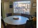 An eat-in dining area features a large round table and a window looking out onto the condo complex at 1025 W Plantation Dr. W # 2817, Little River, SC 29566