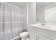 Bathroom featuring a single sink, white vanity, and a stylish gray patterned shower curtain at 1031 Corn Husk Loop, Conway, SC 29527