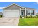 Charming single-story home with manicured lawn, attached garage, and neutral siding at 1031 Corn Husk Loop, Conway, SC 29527