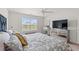 Cozy main bedroom with plush bedding, mirrored nightstands, and bright window at 1031 Corn Husk Loop, Conway, SC 29527