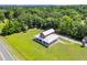 Aerial view of the red house with white trim surrounded by lush greenery at 1039 Forest Dr., Conway, SC 29526