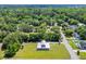 Aerial view of red home and metal roof surrounded by trees and neighborhood at 1039 Forest Dr., Conway, SC 29526
