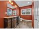 Bathroom featuring warm red walls, double sink vanity, and modern fixtures at 1039 Forest Dr., Conway, SC 29526