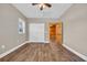 Bedroom showcasing a ceiling fan, closet with white doors, wood grain flooring, and a view into an adjacent room at 1039 Forest Dr., Conway, SC 29526