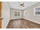 Bedroom with neutral walls, wood grain flooring, ceiling fan, and windows for natural light at 1039 Forest Dr., Conway, SC 29526