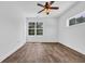 Bright bedroom with large windows, modern vinyl floors, and a ceiling fan at 1039 Forest Dr., Conway, SC 29526