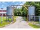 View of a gravel driveway entrance with metal tanks and a peek of the house at 1039 Forest Dr., Conway, SC 29526