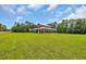 Quaint red barn-style home with a covered porch and large green lawn at 1039 Forest Dr., Conway, SC 29526
