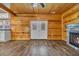 Bright living room with wood paneling, a fireplace, and French doors at 1039 Forest Dr., Conway, SC 29526