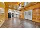 Open-concept living area with wood paneling leading to a modern kitchen at 1039 Forest Dr., Conway, SC 29526