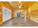Spacious living room with a fireplace, wood paneling, and a ceiling fan at 1039 Forest Dr., Conway, SC 29526
