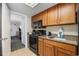 Efficient kitchen with wood cabinets, black appliances, and leads to the living area at 1105 S Ocean Blvd. # 520, Myrtle Beach, SC 29577