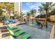 Gathering-friendly splash pad featuring colorful play structures surrounded by lounge chairs and palm trees at 1105 S Ocean Blvd. # 520, Myrtle Beach, SC 29577