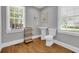 Well-lit bathroom with pedestal sink, elongated toilet, and large window with a view at 1155 Palmetto St., Georgetown, SC 29440