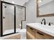 Modern bathroom with a glass-enclosed shower, vessel sink, and rustic-style cabinet at 1155 Palmetto St., Georgetown, SC 29440