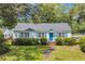 Well-kept single-story home featuring a blue door, shutters, landscaped yard, and a shingled roof at 1155 Palmetto St., Georgetown, SC 29440