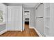 Hallway view leads into a bright bedroom with white closets and wood floors at 1155 Palmetto St., Georgetown, SC 29440