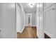 Hallway with hardwood floors and ample storage featuring white doors and cabinets at 1155 Palmetto St., Georgetown, SC 29440
