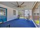 Relaxing screened patio with bright blue floors, comfortable seating, and scenic outdoor views at 1155 Palmetto St., Georgetown, SC 29440