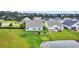 Scenic aerial view of neighborhood homes with lush green lawns and a serene pond at 116 Glengrove Lane, Murrells Inlet, SC 29576